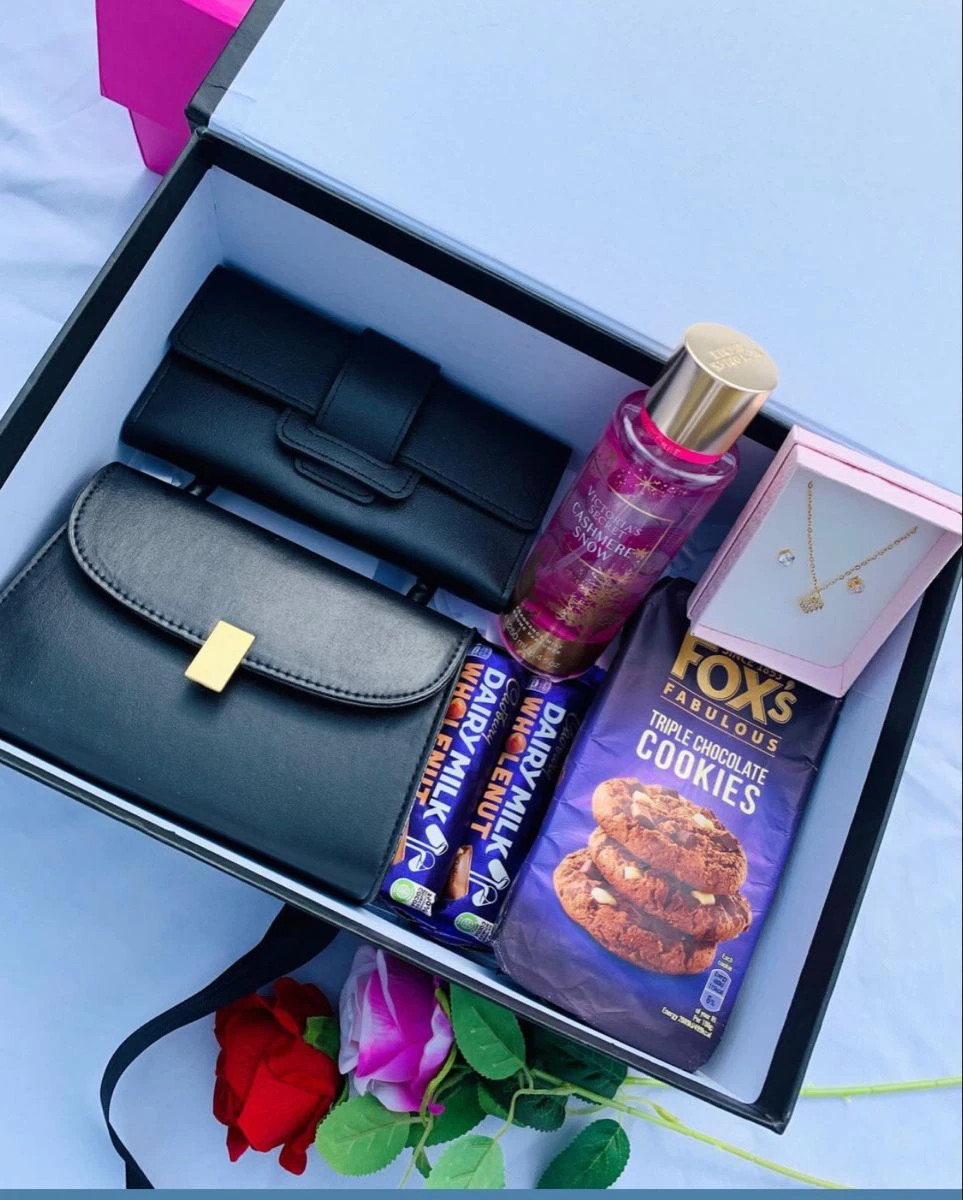 A bag + a mini purse + perfume + chocolate + cookies + necklace Package