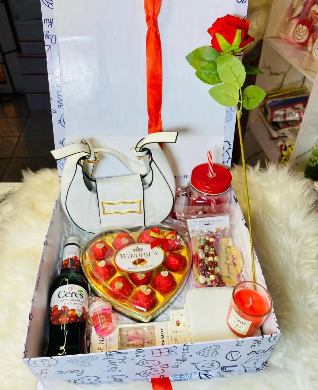 MIni hand bag + Chocolates + Wine + Lip balm + Lip gloss + Nails + Scented candle + Beaded bracelet + Glass mug Package